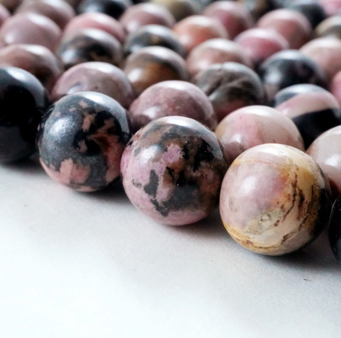 Rhodonite (Round)(Smooth)(4mm)(6mm)(8mm)(10mm)(12mm)(16"Strand)